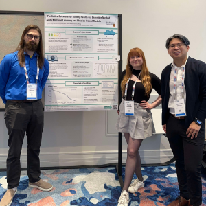 Three people standing around a research poster 