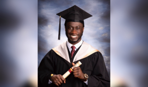 A headshot of Brian Osei-Boateng wearing a convocation robe and mortarboard