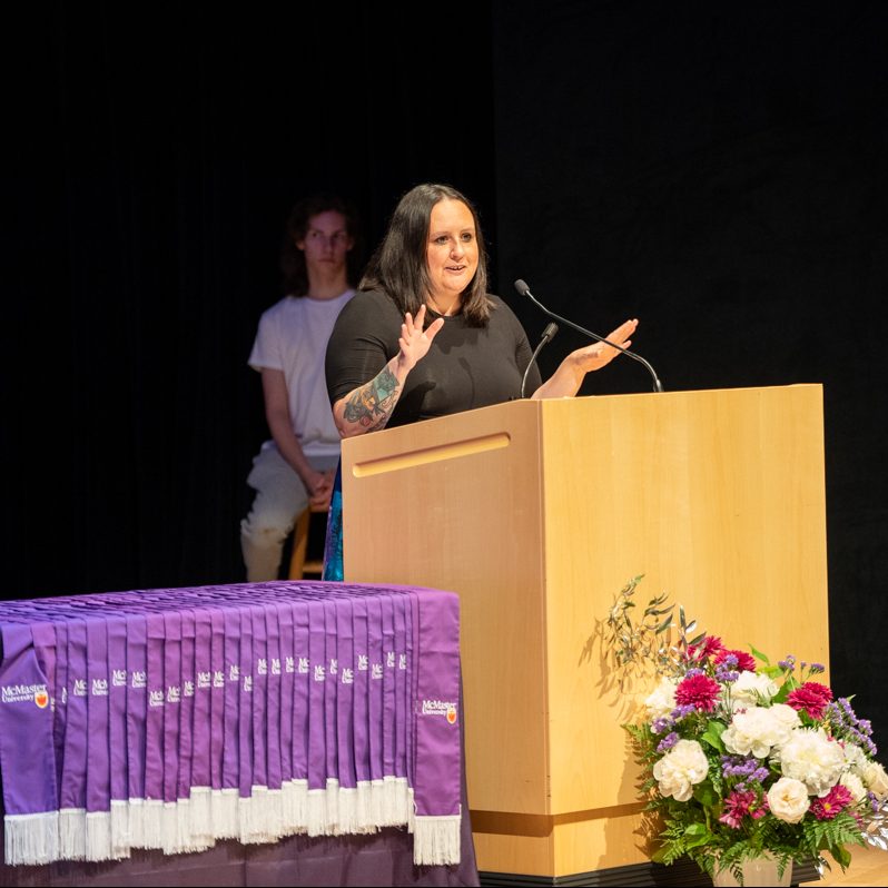 Chrissy Doolittle speaking at a podium on stage.