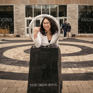 Sheridan Fong posing for a photo with the iron ring on McMaster's campus 