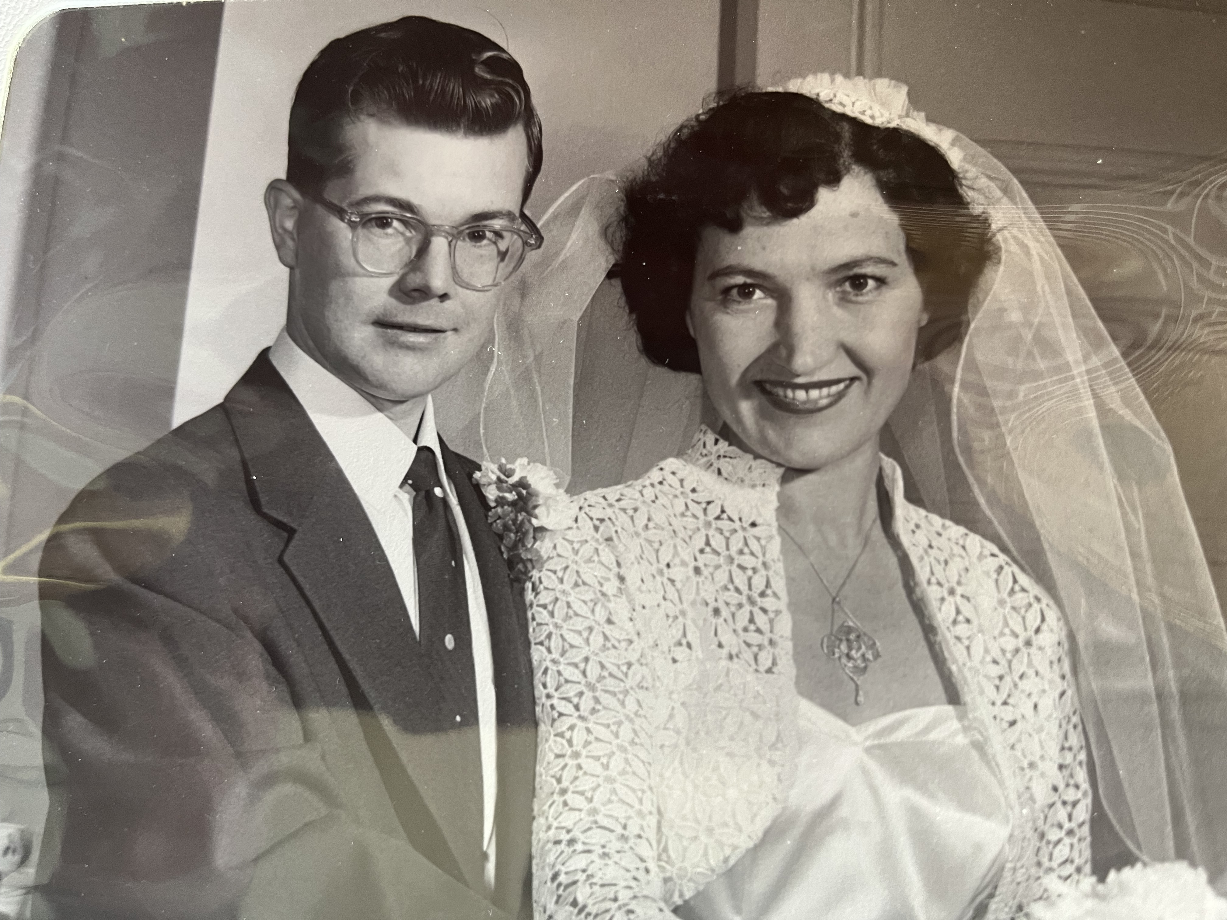 A black-and-white photo of Alan and Janitza Hitchen. Alan is in a suit and tie and Janitza is in a wedding dress and veil. 