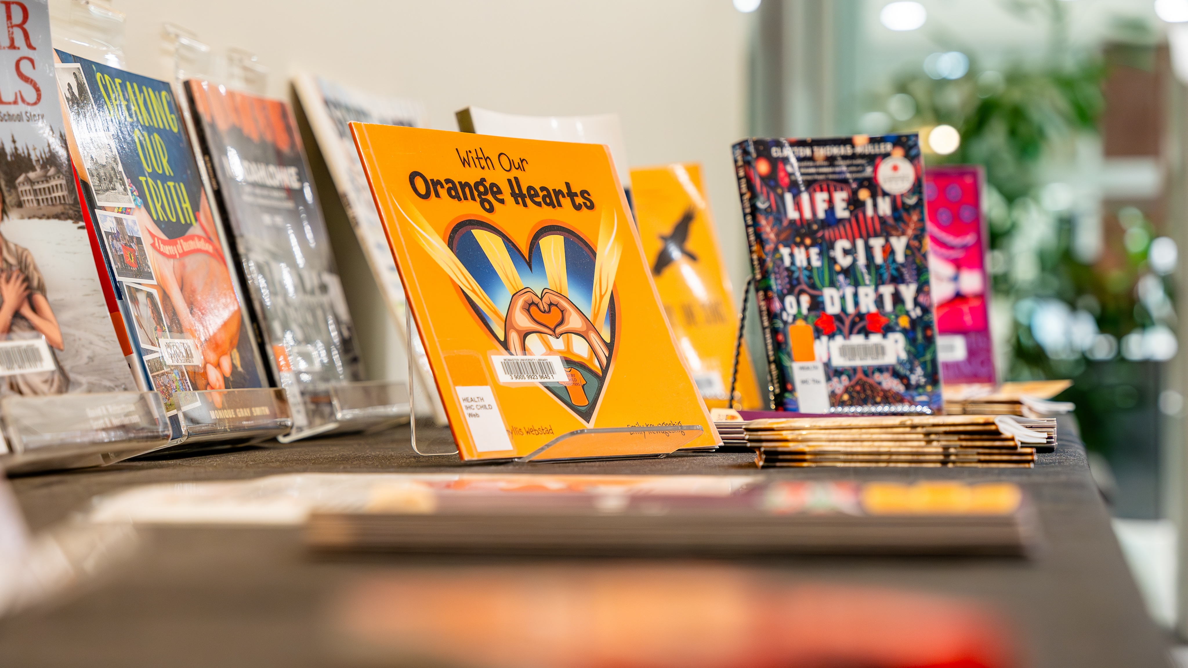 A closeup of several books displayed on a table.