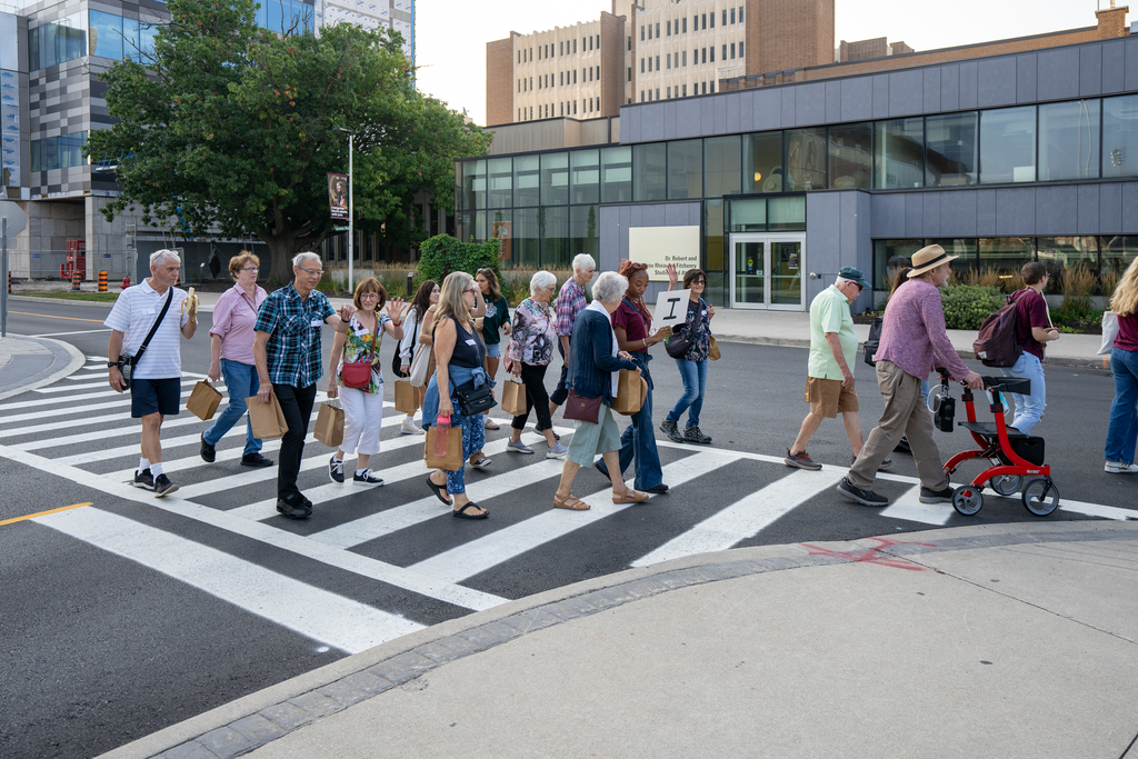 A group of older adults crossing a road 