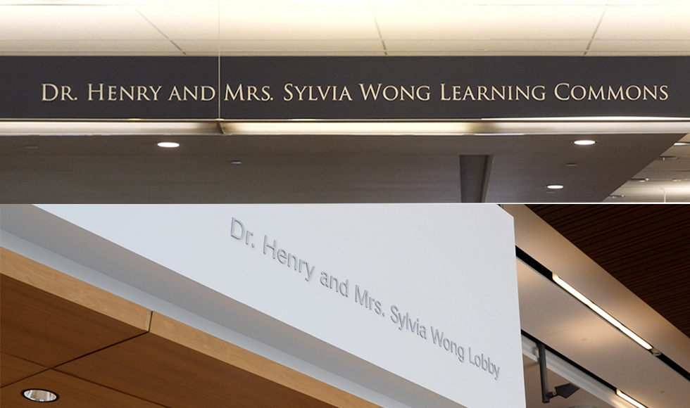 A photo of the new signage. The top sign reads, “Dr. Henry and Mrs. Sylvia Wong Learning Commons,” while the bottom reads, “Dr. Henry and Mrs. Sylvia Wong Lobby.”