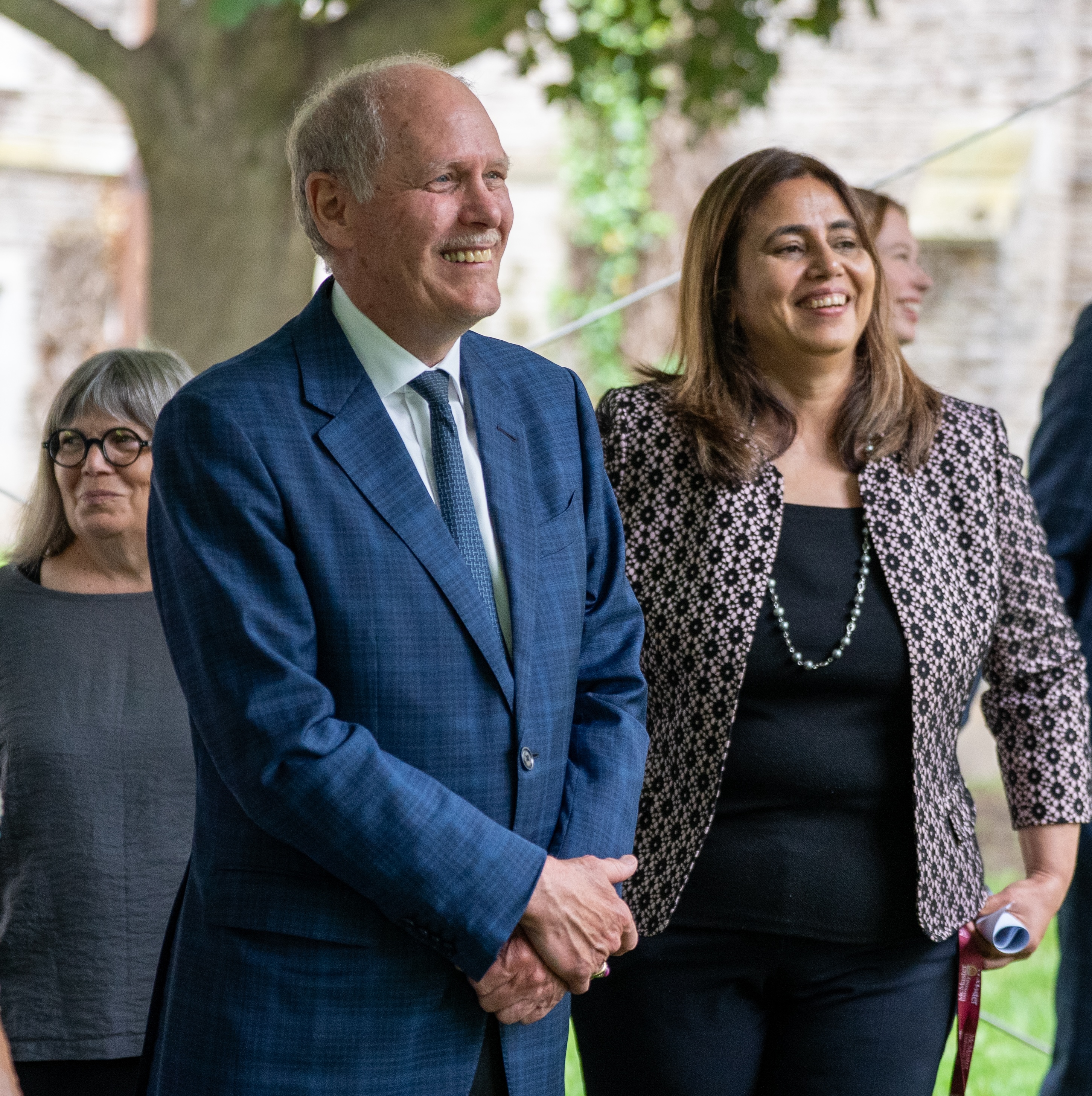 David Farrar and Saher Fazilat smiling as they stand together outdoors on campus.