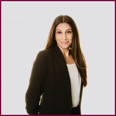 A headshot of a woman wearing a blazer.