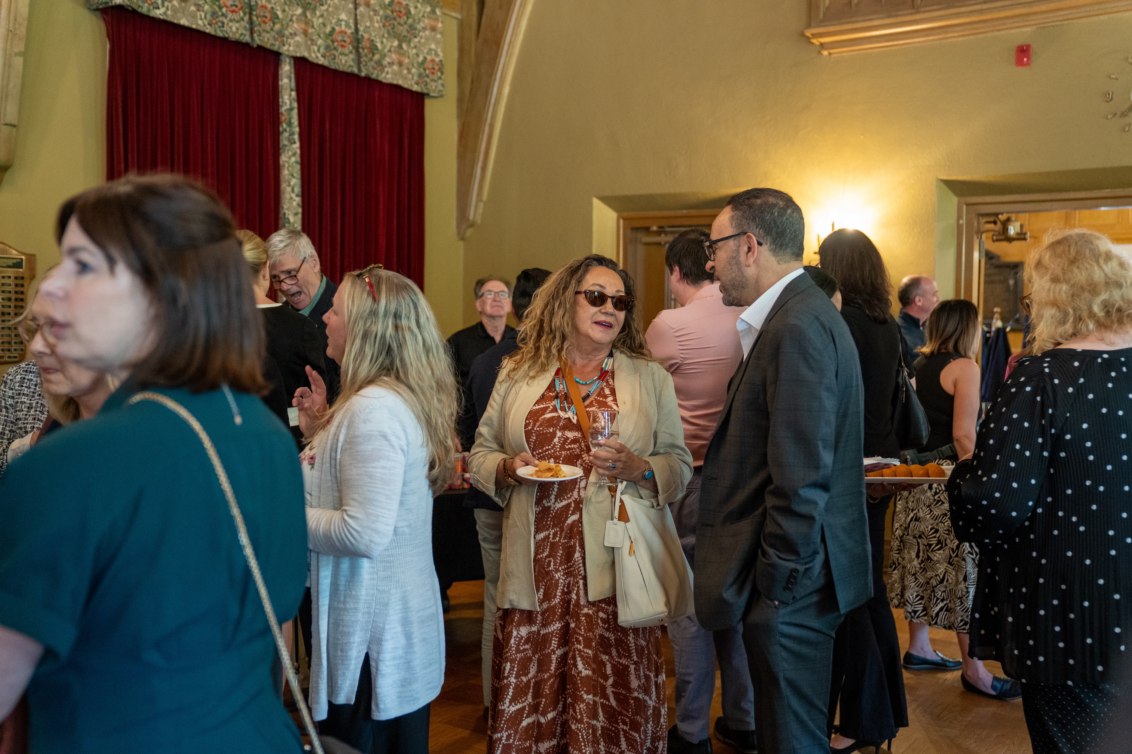 Dawn Martin-Hill and Khaled Hassanein chat during a gathering in Alumni Memorial Hall