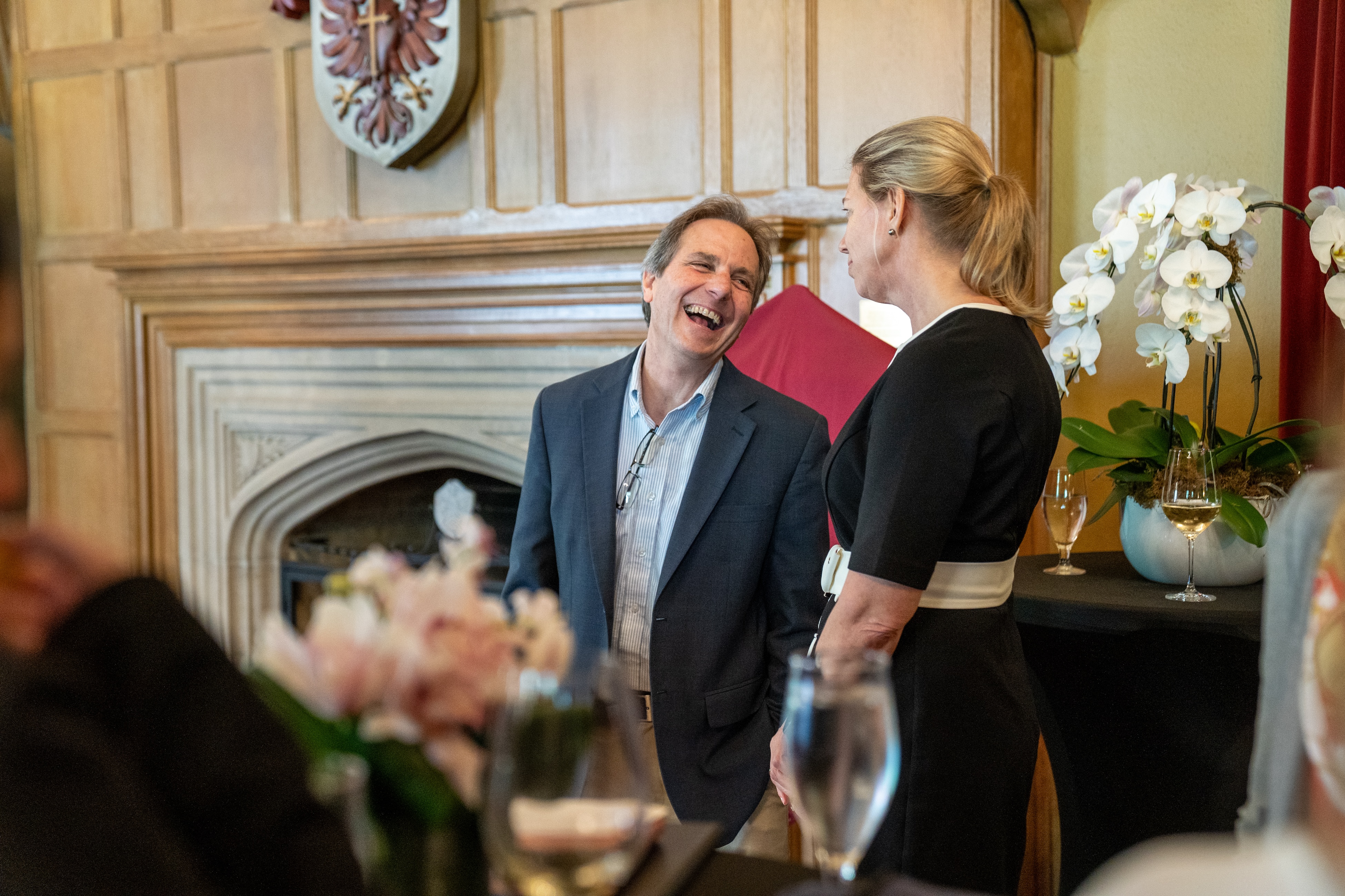 Jerry Hurley and and Maureen MacDonald chat and laugh during a gathering in Alumni Memorial Hall