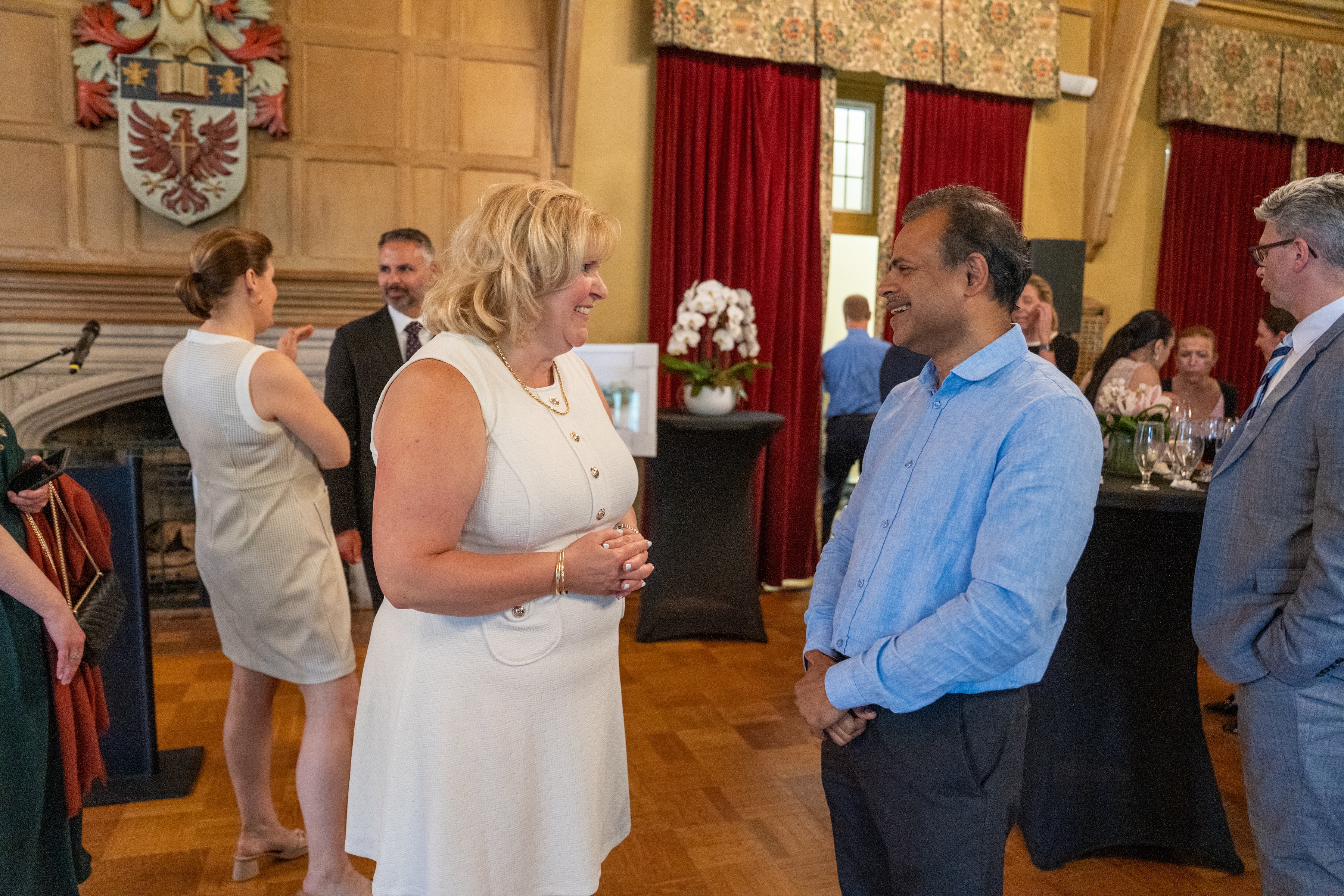 Susan Tighe and Bhagwati Gupta chat during a gathering in Alumni Memorial Hall