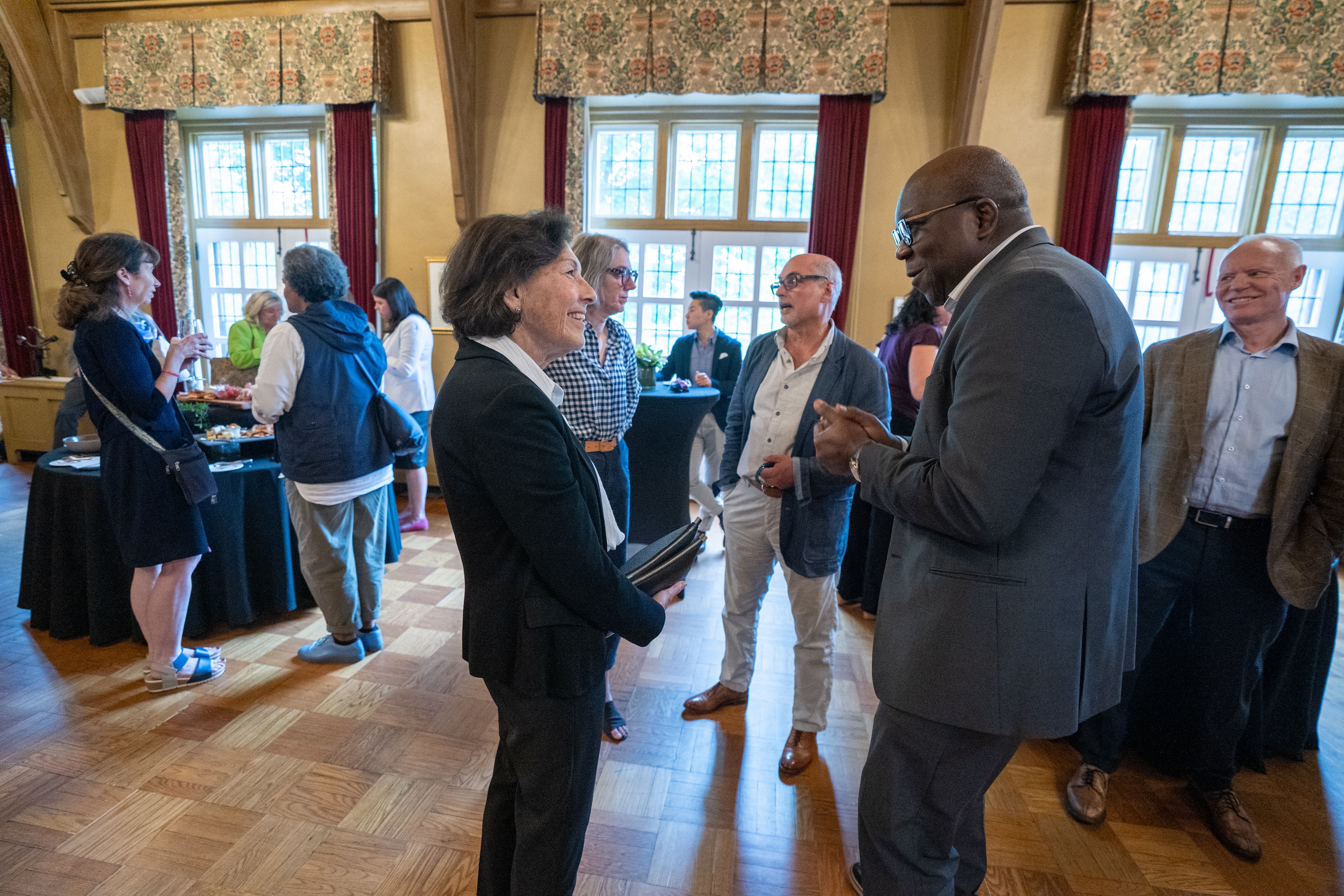 Susan Denburg and Bonny Ibhawoh chat during a gathering in Alumni Memorial Hall