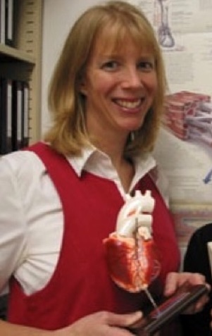 Maureen Macdonald holds a model of the human heart.