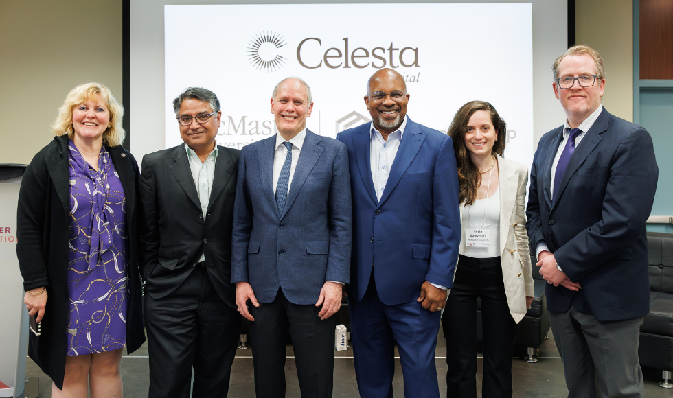 Six people in suits smile, facing camera. A projector screen presentation with Celesta logo is behind them.