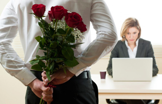 Excited and surprised businesswoman receiving red roses