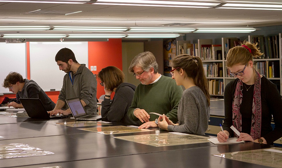 Students from Arts and Science 3BB3: Technology and Society II work with map expert Gord Beck, Maps Specialist, Maps, Data, GIS (second from the right) on an experiential learning project featuring a number of the rare maps contained in McMaster’s Lloyd Reed Maps Collection.