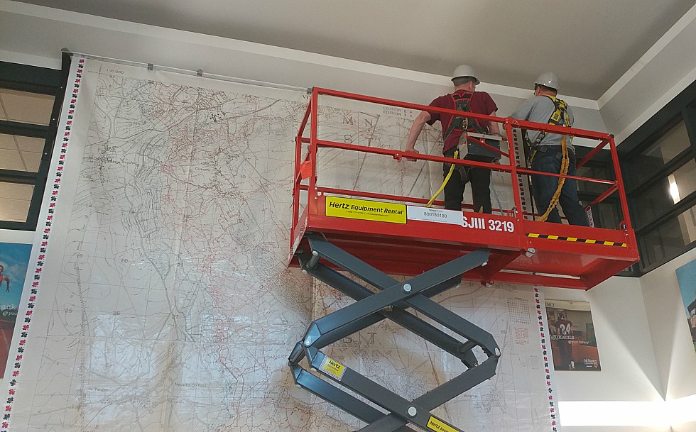 Workers install a 17ft. by 13 ft. large scale map of Vimy Ridge in the foyer of Mills Library. The map, which will be on display until November 21, was created by Canadian Geographic using trench maps from McMaster’s extensive WWI collection and is available on loan to schools across Canada to help teach students about the Battle of Vimy Ridge.