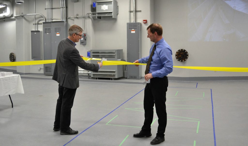 Bruce Gaulin, director of the Brockhouse Institute for Materials Research, left, and Chris Heysel, director of nuclear operations, cut the ribbon to celebrate the completion of the SANS — small angle neutron scattering — guide hall in the Nuclear Research Building.