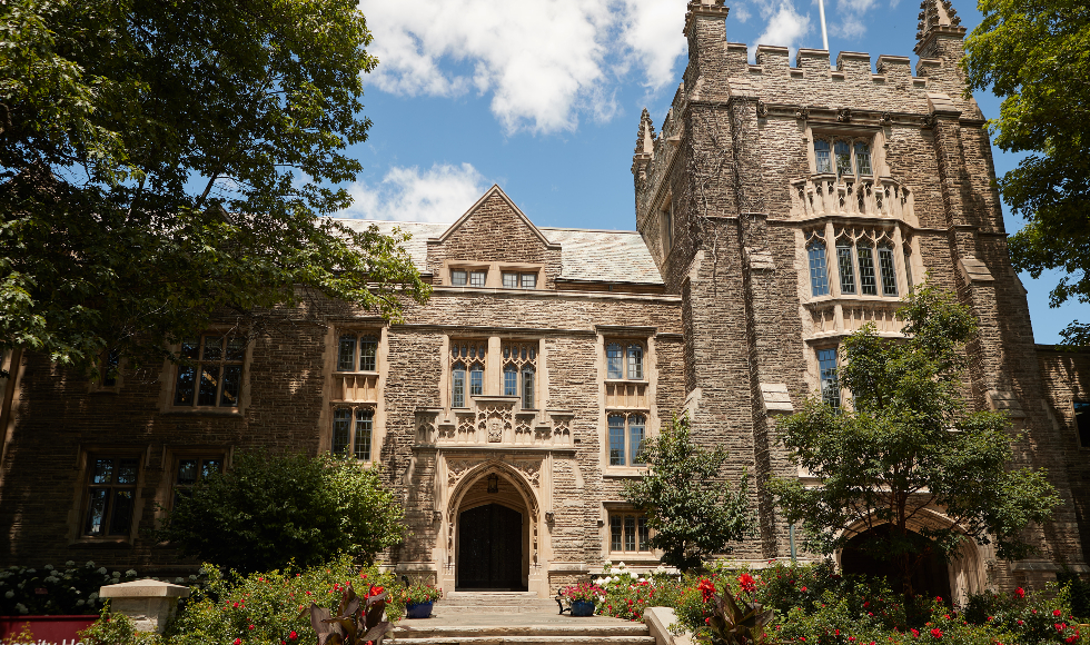 Photo of McMaster University Hall in summer with red roses