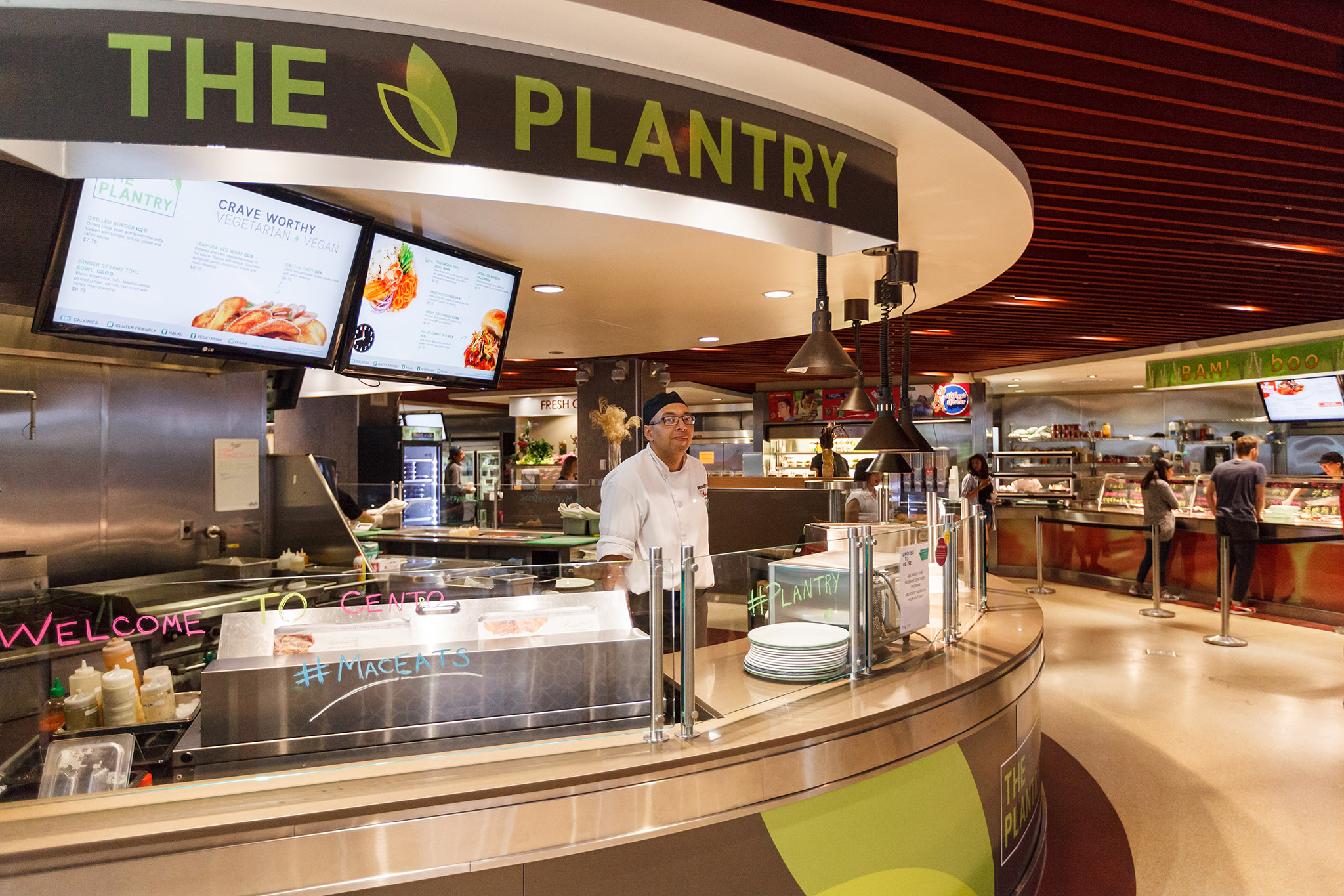 Employee working behind a counter in La Piazza eatery stand