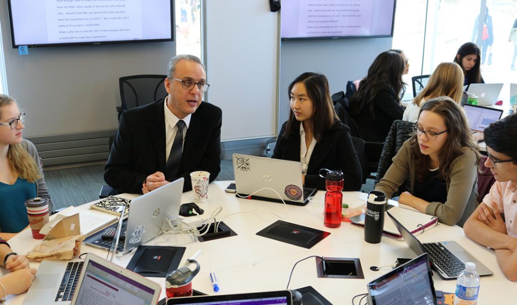 IBH program director Emad Mohammed talks to students.