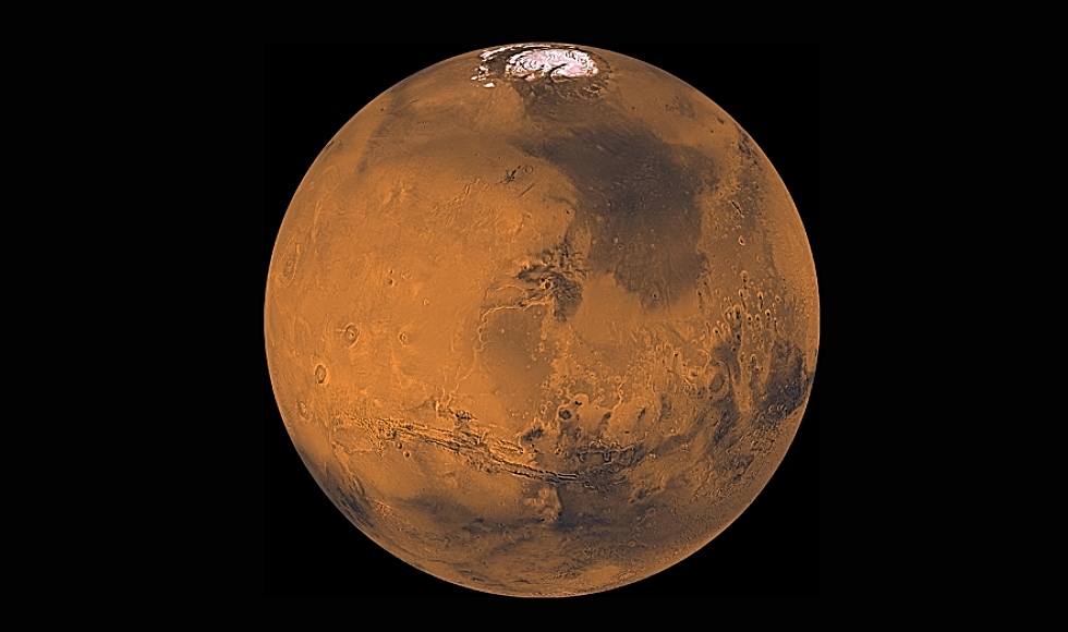 About 1000 images taken by the Viking Orbiter have been processed to create this image of Mars. The north polar cap is visible in this projection at the top of the image, the great equatorial canyon system (Valles Marineris) below center, and four huge Tharsis volcanoes (and several smaller ones) on the left. Heavy impact cratering of the highlands (bottom and right portions of the image) can also be seen. Image Credit: NASA/JPL/USGS