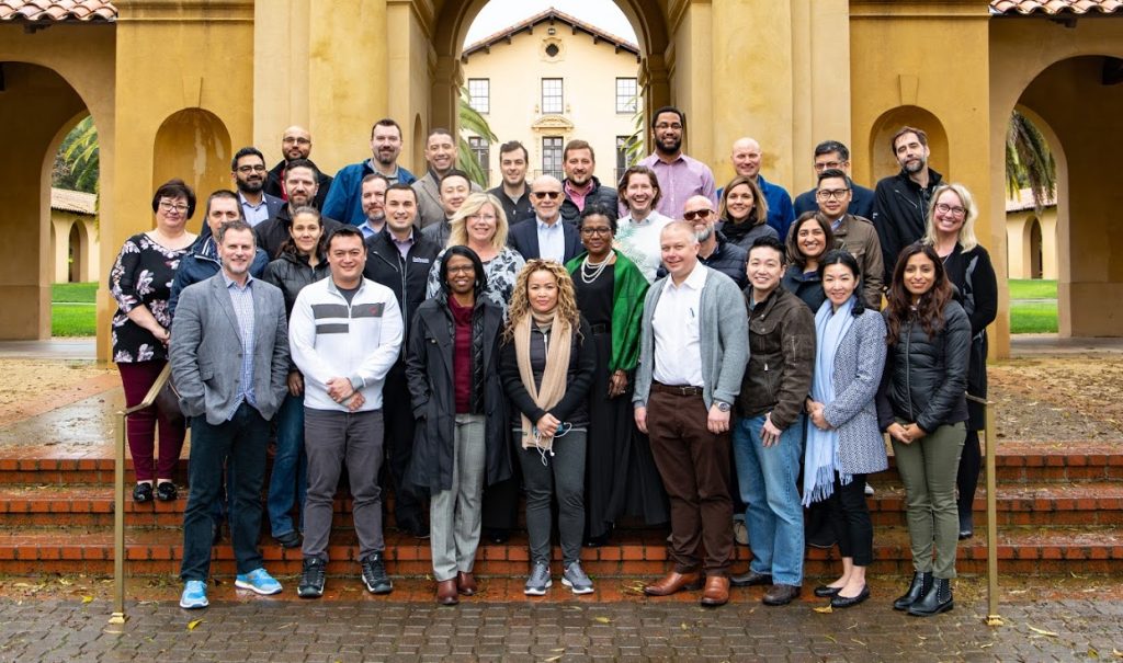 Group photo of entire EMBA cohort posing in front of a California building on their trip.