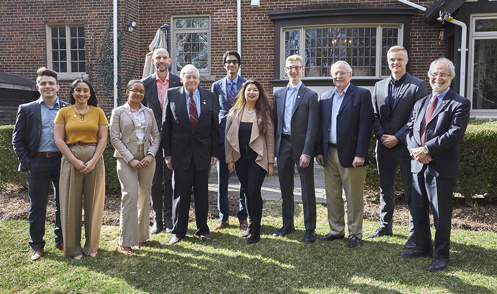 Seven Wilson Leader Scholars standing outside with Scholarship founder Lynton “Red” Wilson and McMaster President Patrick Deane and AVP and Dean of Students Sean Van Koughnett.
