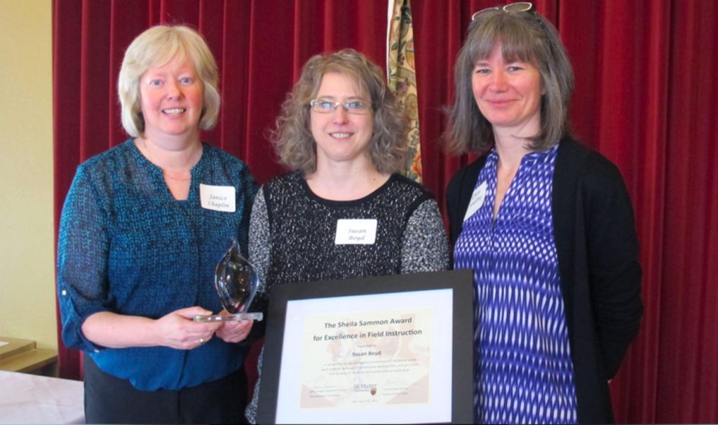 Janice Chaplin, Susan Boyd and Chris Sinding stand together with Boyd's certificate for the Sheila Sammon award.