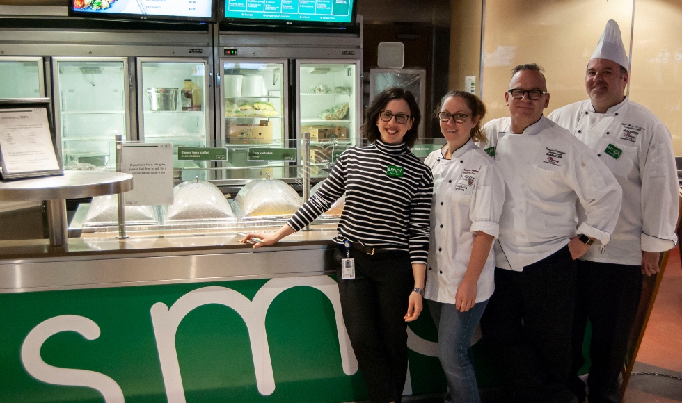 McMaster chefs stand in front of the meal counter at SMPL