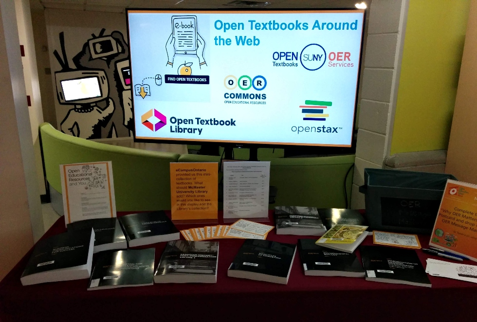 Open Education Week Display with a monitor and a selection of open textbooks.