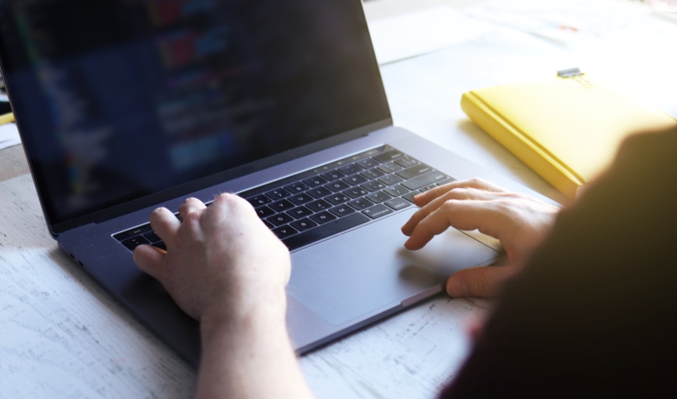 Shot of a students hands typing on a laptop