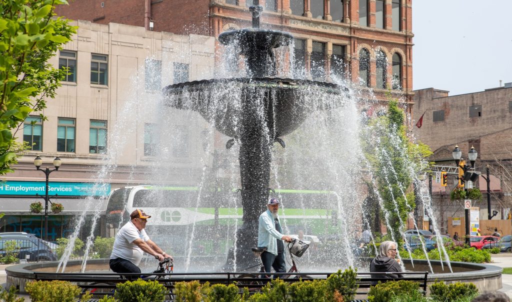 Two cyclists near the fountain in Gore Park.