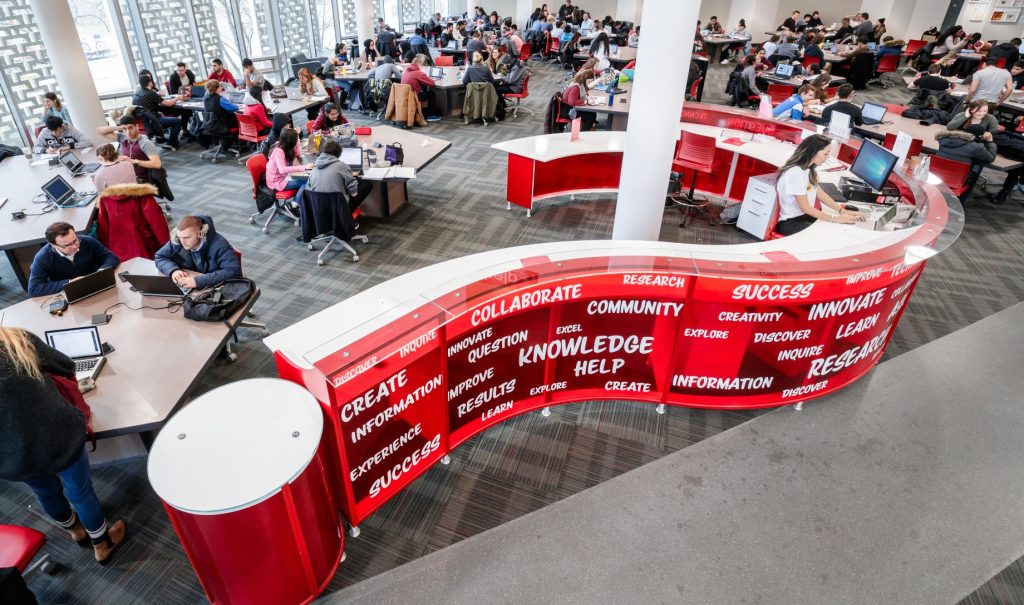 Overhead view of the question-mark shaped help desk in the Learning Commons in Mills LIbrary, aka the 