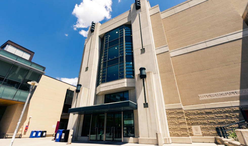 Shot of Mills Library with a blue sky in the background