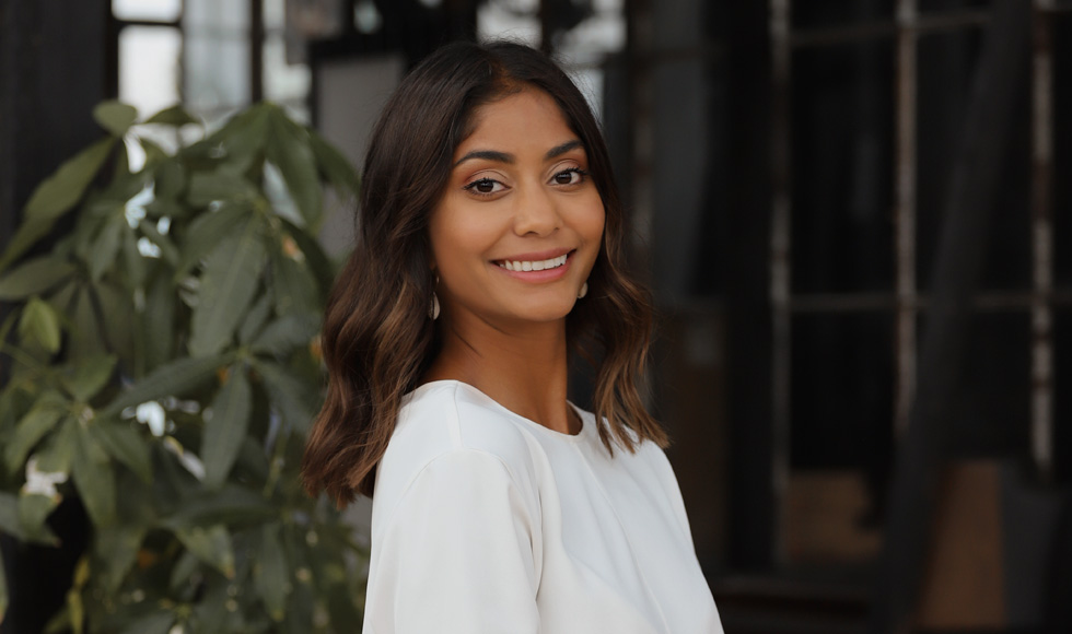 A head-and-shoulders shot of a young southeast Asian woman smiling