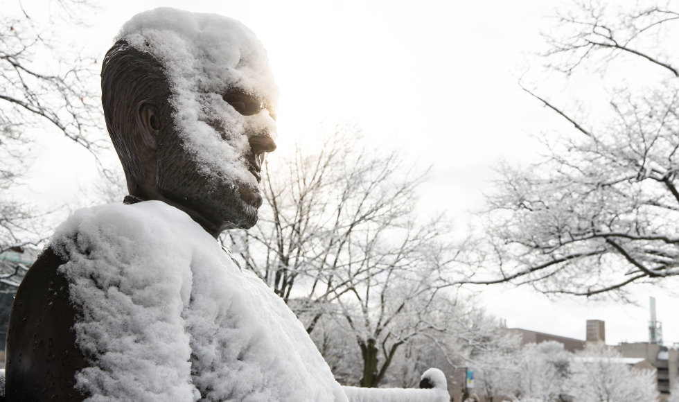 A statue of Senator William McMaster covered in snow