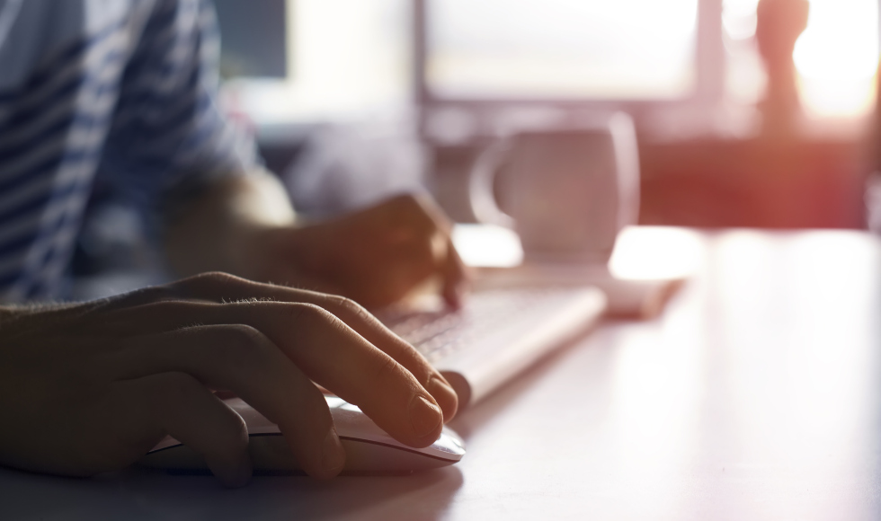 Hands at a laptop keyboard