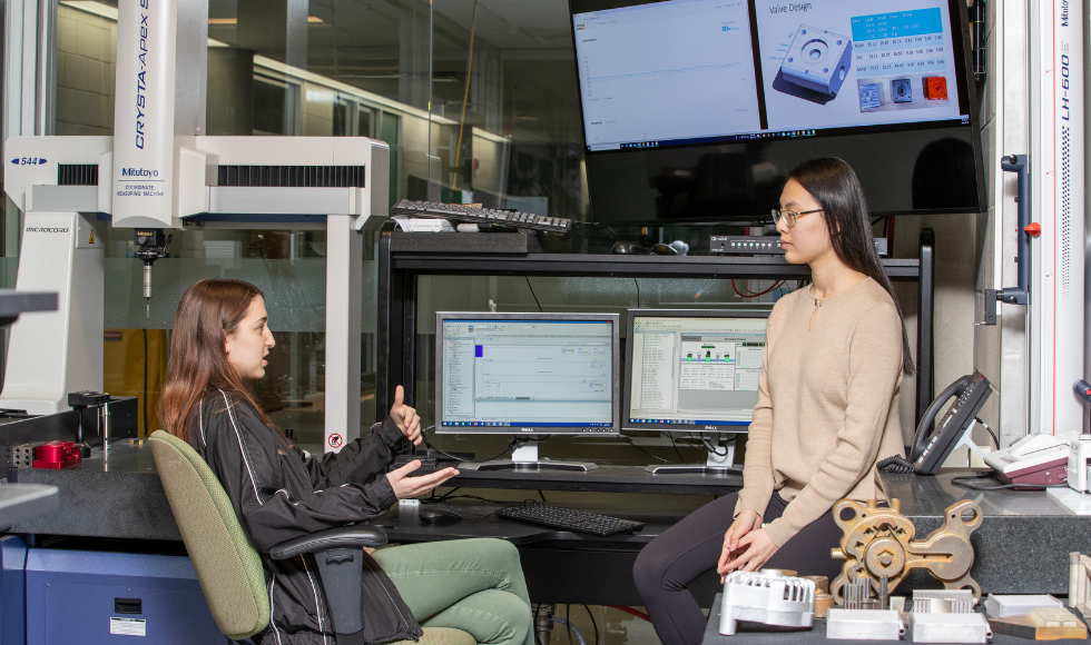 Two students collaborate on a project.