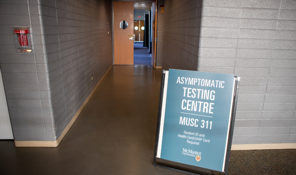 Sandwich board sign of Asymptomatic testing centre outside of entrance.