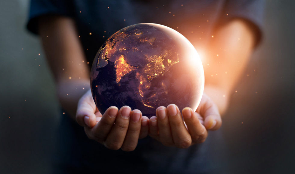 Woman holding a globe of planet earth