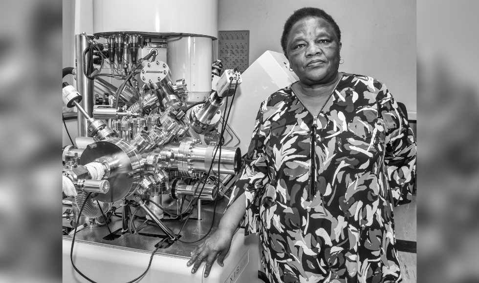 Photo of Tebello Nyokong standing beside lab equipment.