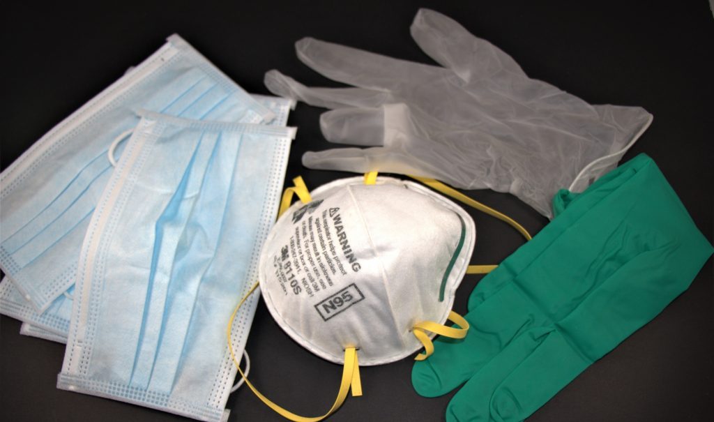 N95s, surgical masks and gloves on a table