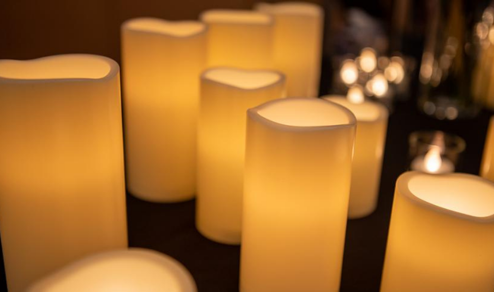 A closeup of many lit candles.