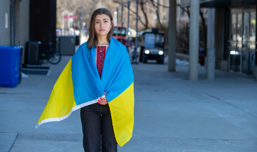 A student wrapped in a Ukrainian flag