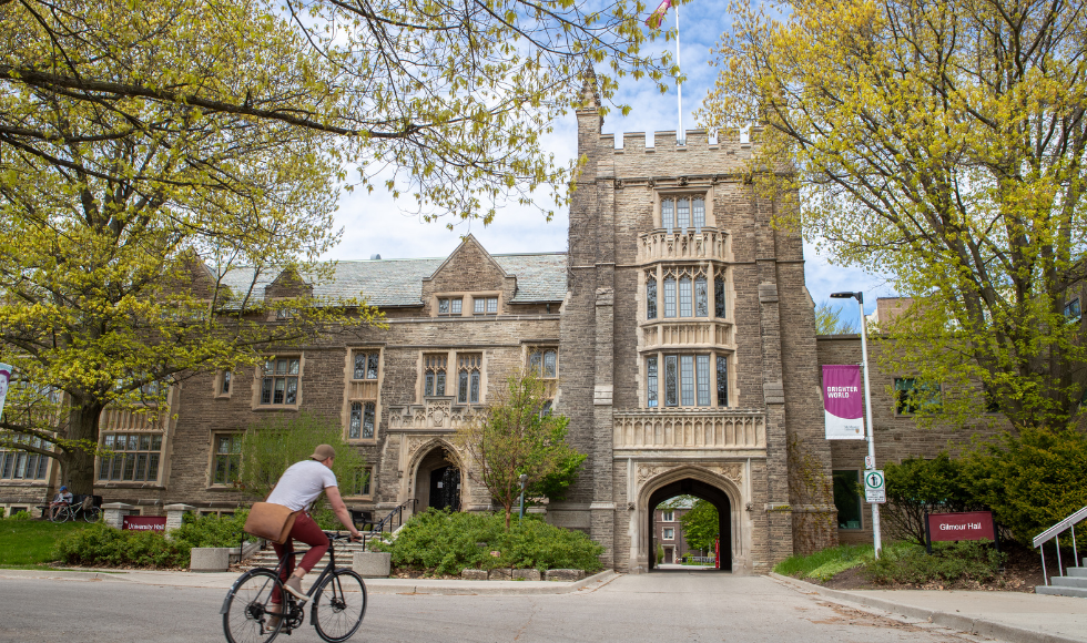 McMaster Univeristy's University Hall with a cyclist in the foreground
