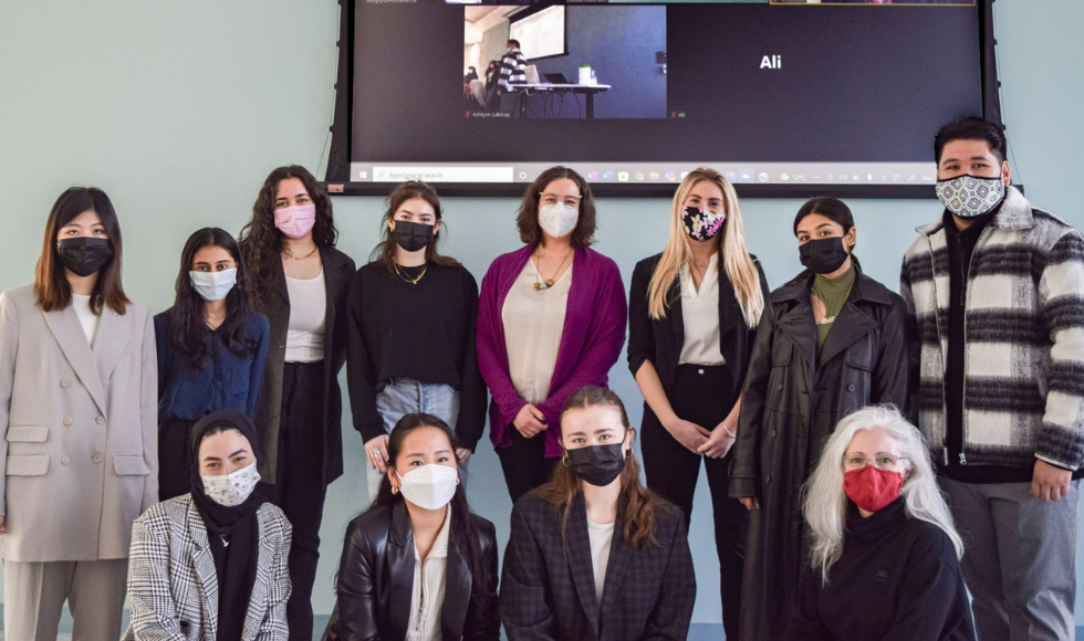12 masked people posing for a photo