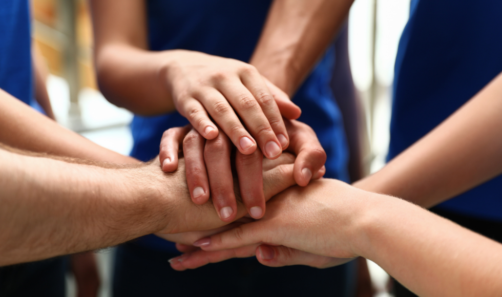 A tight shot of hands placed on each other