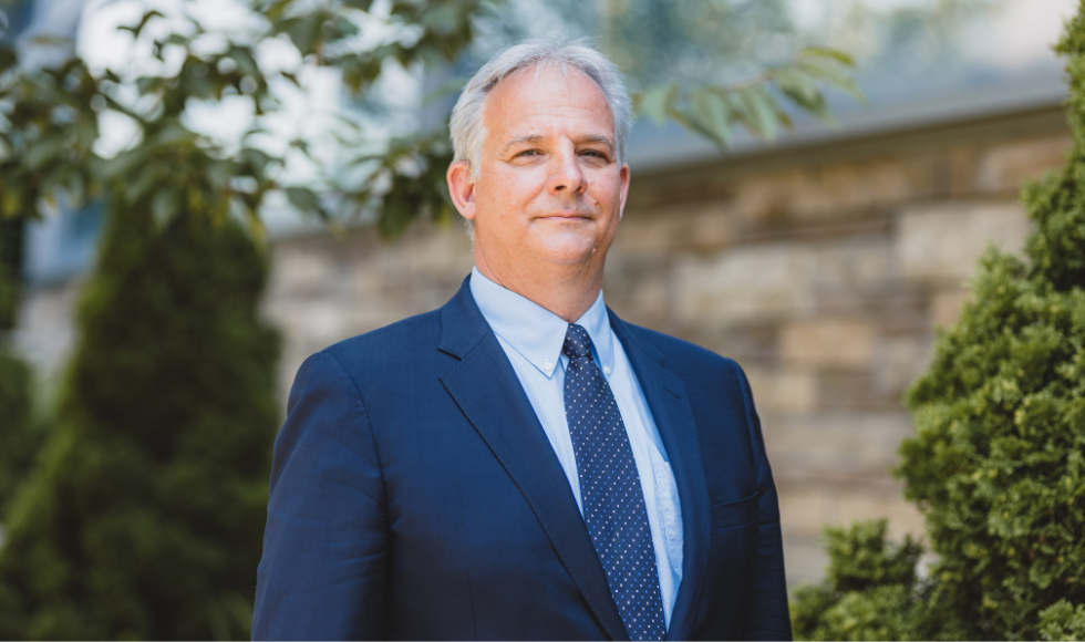 Head and shoulders of a smiling Marc Jeschke standing outdoors