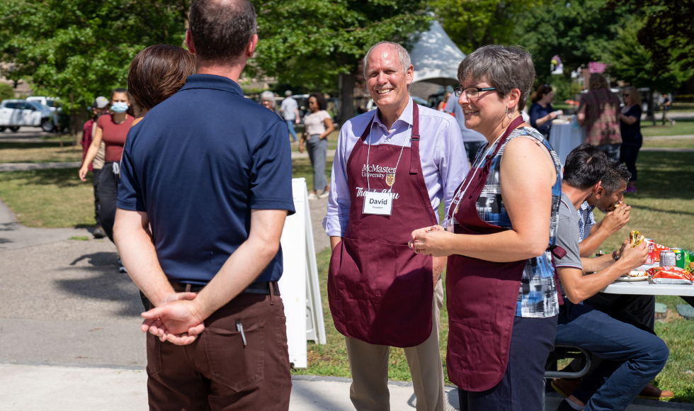 president David Farrar, research VP Karen Mossman serve burgers at staff BBQ