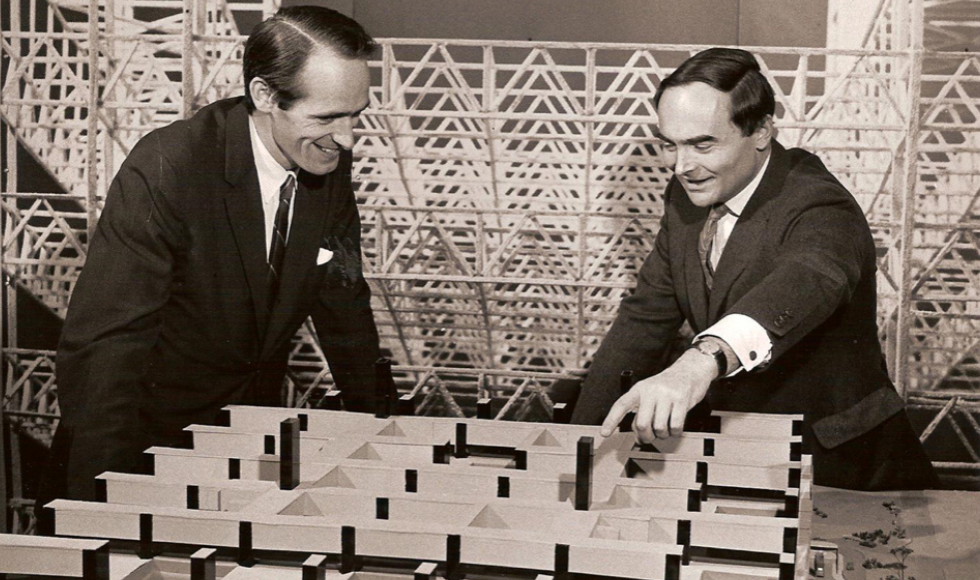 Historical image of two men looking at the model of the McMaster University Medical Centre