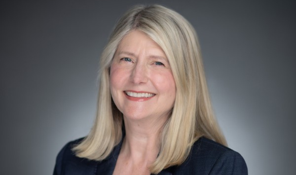 A headshot of Jane Allen smiling at the camera.